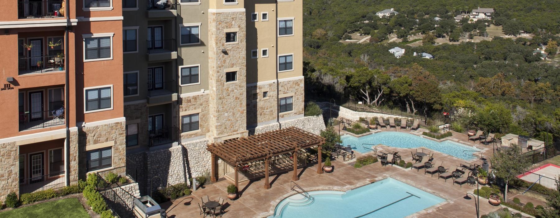 a large building with a pool in front of it