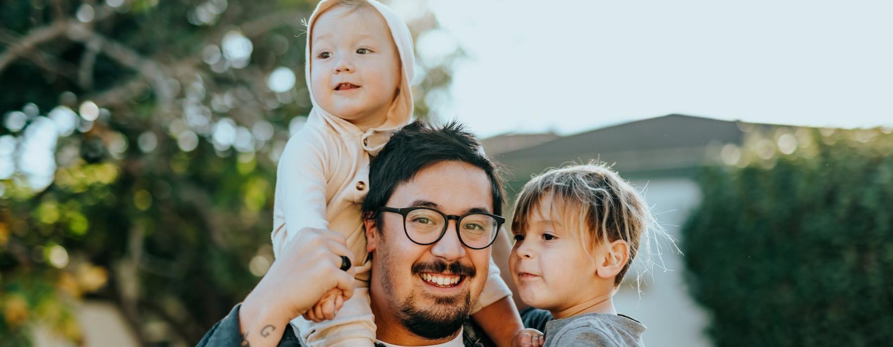 a person holding a couple of children