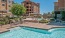 a pool in a courtyard with buildings in the background