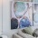 a room with a couch and a table with a painting on the wall
